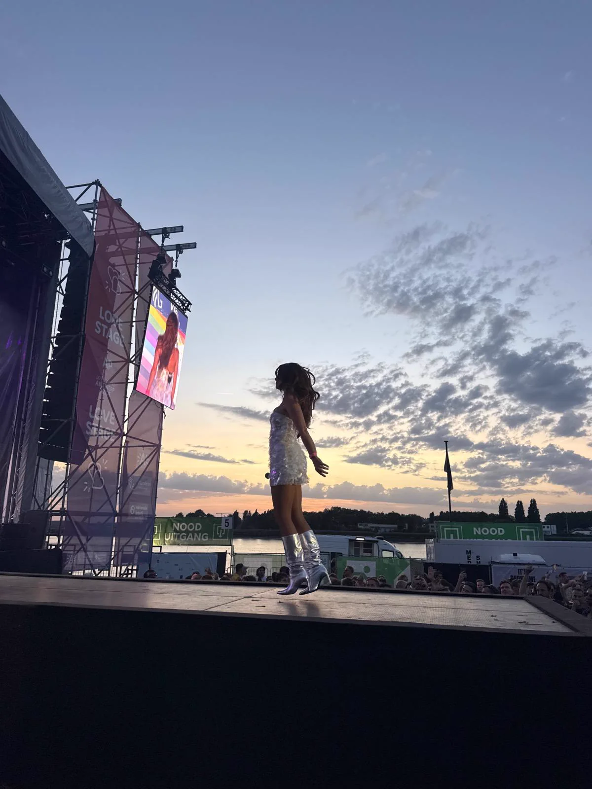 Katerine silhouetted against the sunset at Antwerp Pride 2026